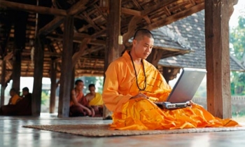 A Thai monk using the internet. From The Guardian.