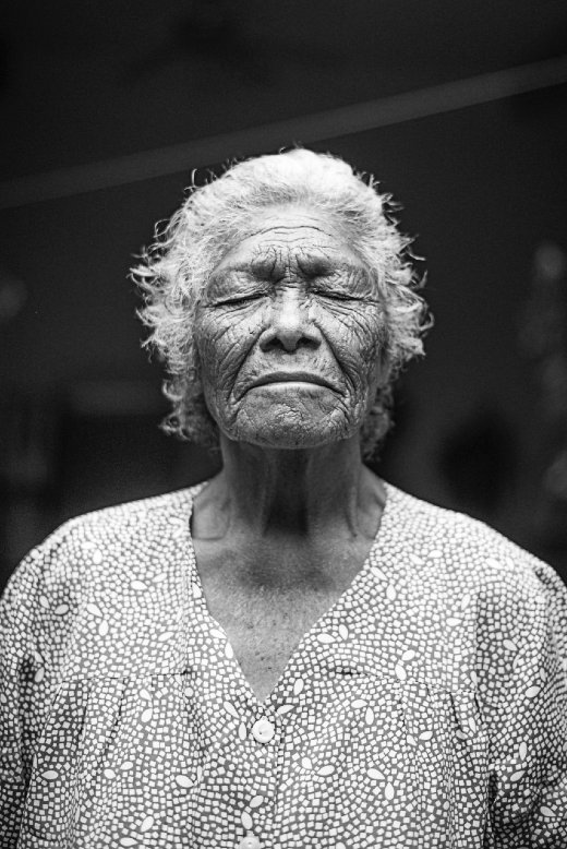 Black and white photo of elderly woman of color with her eyes closed