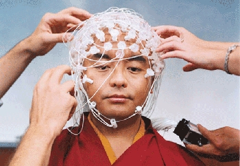 Teacher and master Mingyur Rinpoche posing with nodes and circuits that measure his states of mind.