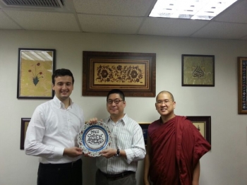 Mudjat Yelbay with Ben Kwong and Ven. Dhammapala. The plate, lavishly decorated with turquoise, burgundy, and much more, is from Mr. Yelbay's hometown of Nicaea.