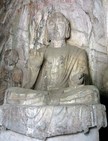 Tang Dynasty Amitabha sculpture — Hidden Stream Temple Cave, Longmen Grottoes, China. From Wikimedia.