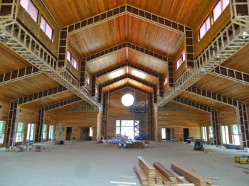 Massive barn-like interior space lined with soothing natural materials of wood and stone. photo: © Buddhistdoor