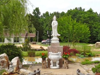 Avalokiteshvara's serene presence in the lotus pond garden. photo: © Buddhistdoor