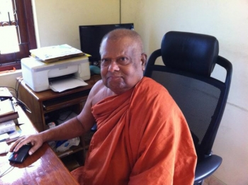Ven. Anuruddha at his desk - a common sight for his students.