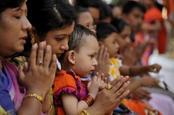 People attend a mass prayer to mark Buddha Purnima, the biggest religious festival of the Buddhists, in Dhaka, Bangladesh, on May 9, 2009. From Xinhua.