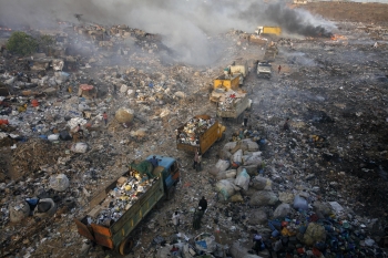 Trucks line up to offload rubbish at Olusosun dump in Nigeria's teeming commercial capital Lagos. From Citylab.