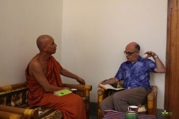 John Cannon in deep conversation with Ven. Buddhadatta. From Jnan Nanda for BDI.
