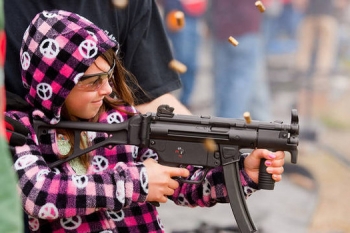 Child shooting gun at shooting range. From examiner.com