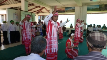 Youths at Parahita Monastery performing a traditional dance to thank rice donors