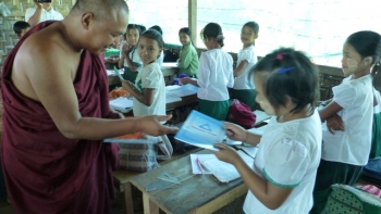 Venerable Aggasara giving out free exercise books at Baka School