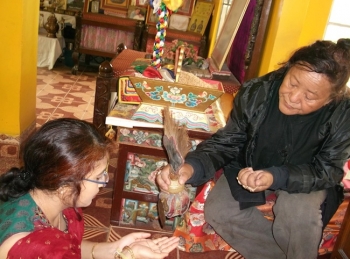 Dr. Ramala Sarma (L) praying before C. S. Lama (R)