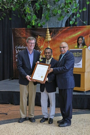 Ottawa Mayor Jim Watson (left) presents a framed 