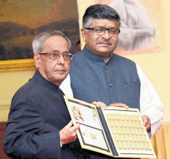 From left: Pranab Mukherjee, president of India, and Ravi Shankar Prasad, union minister for communications, holding new stamp of Anagarika Dharmapala. From www.thehindu.com