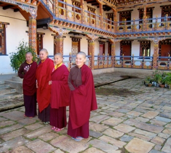 Nuns in courtyard with elaborate paintwork