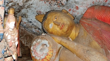 Reclining Buddha in Danagirigala, with damage to the eye and pillow. From newindianexpress.com