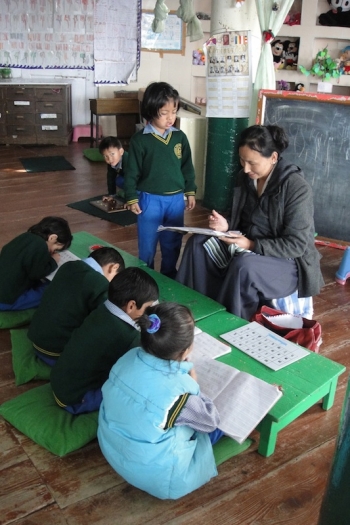 Teacher with students at the Tibetan Children's Villages (TCV)