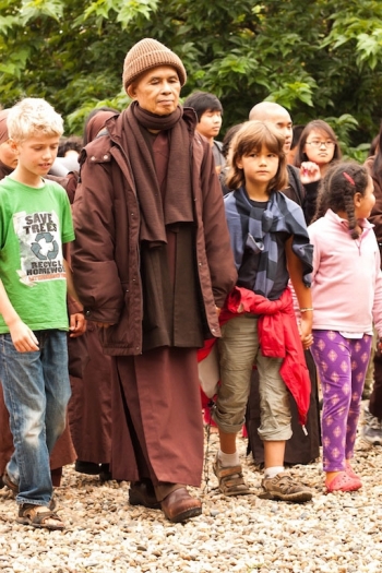 Thich Nhat Hanh walking with children at Plum Village hamlet, France, July 2014. From plumvillage.org