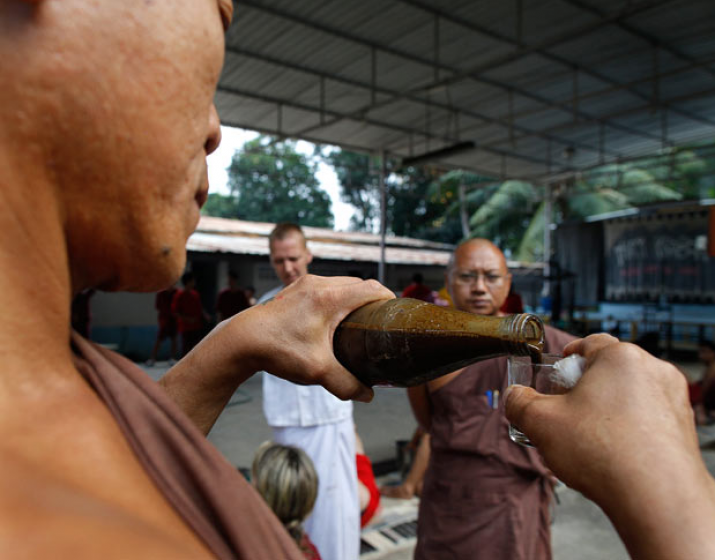 A monk distributes a herbal detoxification brew to drug addicts before the vomiting session begins at Wat Thamkrabok in Saraburi Province, Thailand. From telegraph.co.uk