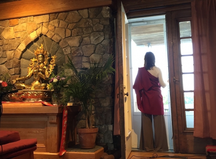 Lama Willa Miller looking out to the mountain from Wonderwell's meditation hall. Photo by Harsha Menon