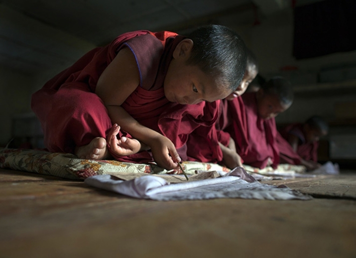 Novices read during class at Dechen Phodrang Monastery in Bhutan. From theguardian.com