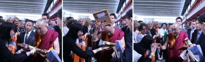 Carmen Mensink offering her artwork to HH the Dalai Lama, who blesses it on his head