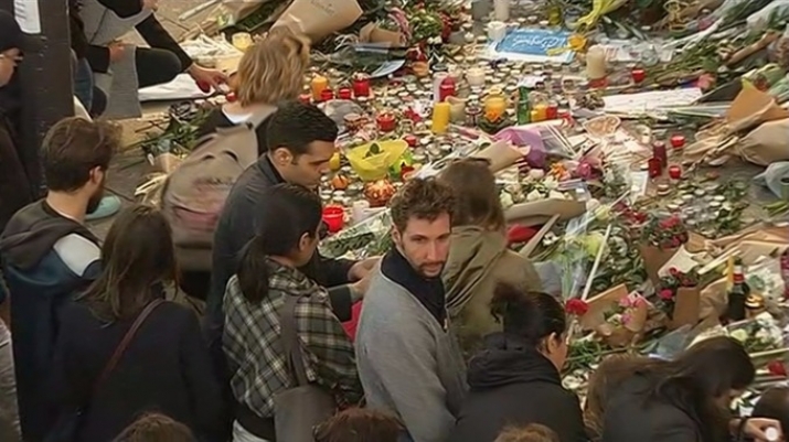 Mourners gather outside Paris café Le Carillon, one of the targets of Friday's attacks. From itv.com
