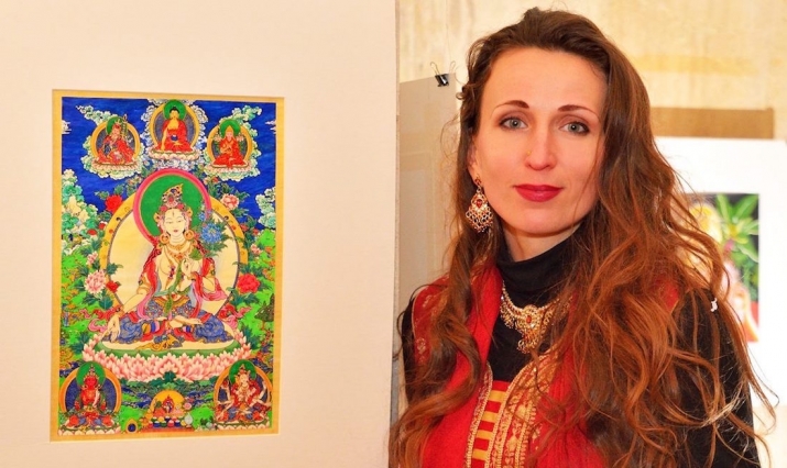 Lucy with her painting of White Tara during the opening of her exhibition <i>Mirror of the Heart</i>, in the Alma Mater Gallery of Sofia University. Image courtesy of the author