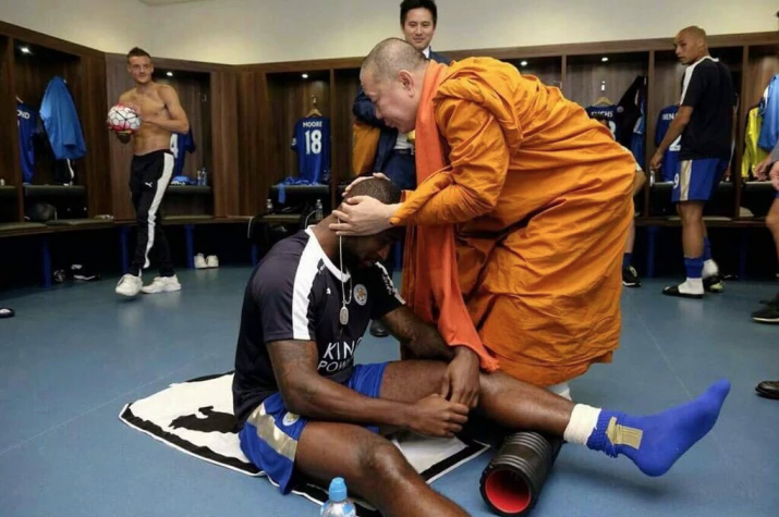 A Thai Buddhist monk provides Leicester City team members with some pre-match motivation. From sportingnews.com