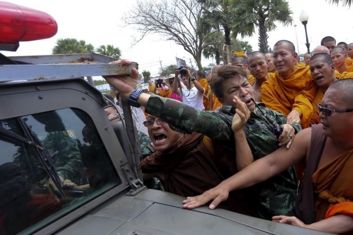 Thai monks scuffle with a soldier during a rally against state interference in religious affairs on the outskirts of Bangkok. From reuters.com