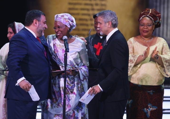 Actor and humanitarian George Clooney, co-chair of the selection committee, presents the Aurora Prize to Marguerite Barankitse at a ceremony in Armenia. From auroraprizemedia.com