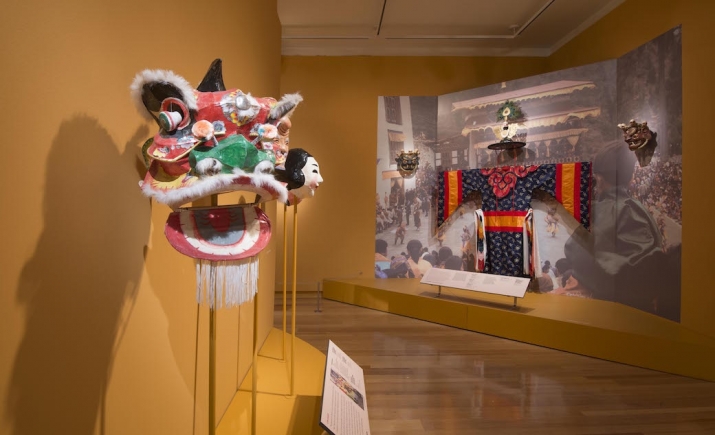 Black Hat Cham costume and Cham masks (far wall), <i>Sacred Realm: Blessings and Good Fortune in Asia</i> exhibition, Museum of International Folk Art, Santa Fe, New Mexico, 2016. Image courtesy Felicia Katz-Harris