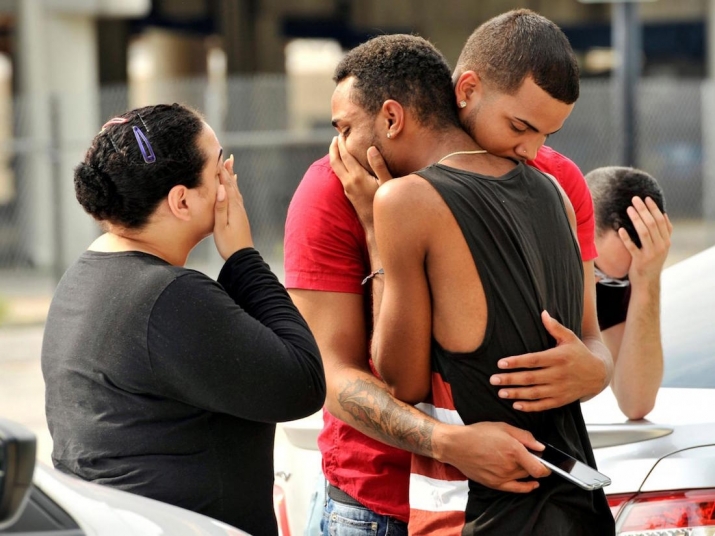 Friends and family members comfort one another following the mass shooting at the Pulse nightclub in Orlando, Florida. From independent.co.uk