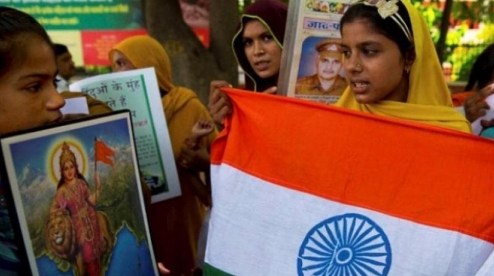 Refugees from Pakistan who live in India hold the Indian flag as they protest in New Delhi on Pakistan’s Independence Day. From deccanchronicle.com