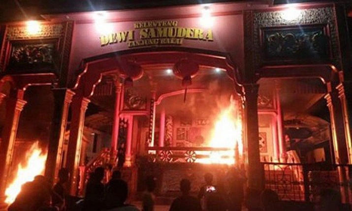 Residents gather in front of Dewi Samudera, a Buddhist temple in Tanjungbalai, which was plundered and set ablaze by an angry mob late last month. From thejakartapost.com