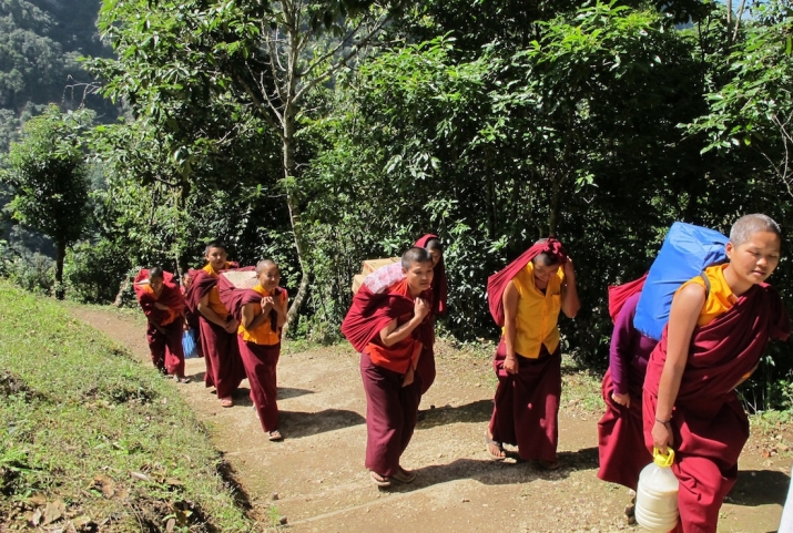 Nuns carrying daily necessities to their nunnery. Image courtesy of the Bhutan Nuns Foundation
