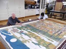 Conservators remove the outer border of the scroll's mount. From hyperallergic.com