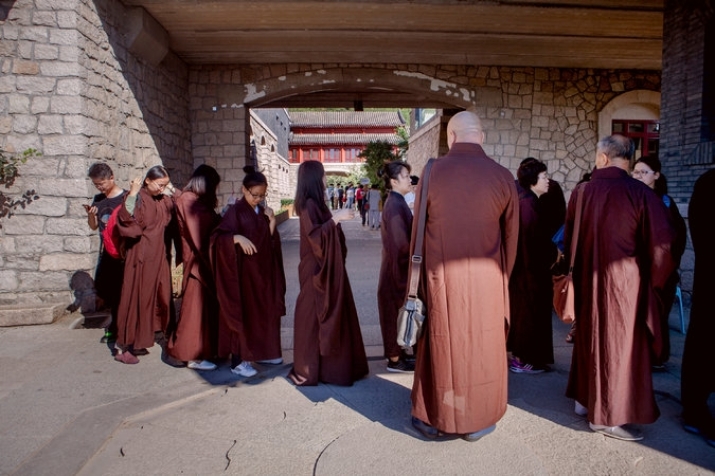 Lay visitors prepare to enter Longquan Monastery's meditation area. Photo by Giulia Marchi. From nytimes.com