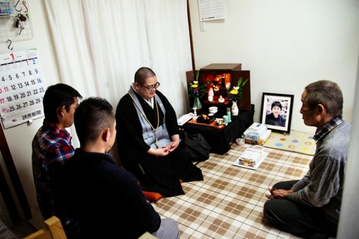 A Buddhist monk leads prayers for a memorial ceremony in a family home. Photo by Ko Sasaki. From nytimes.com