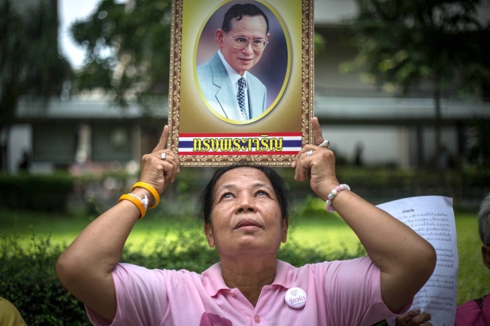 A well-wisher prays for the health of the Thai king. From time.com