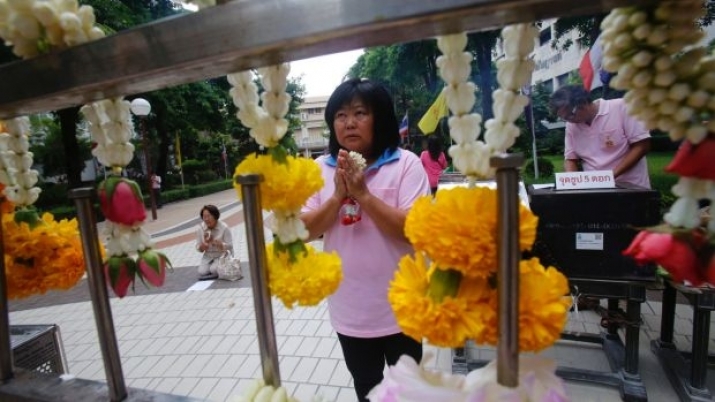 A woman prays at Bangkok's Siriraj Hospital where the Thai king is being treated. From smh.com.au