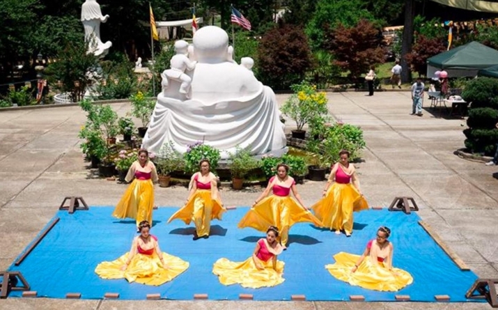 A youth group dances during celebrations for the Buddha's birthday