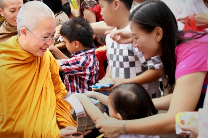 Ayya Santini collecting alms from lay Buddhists. Image courtesy of the author