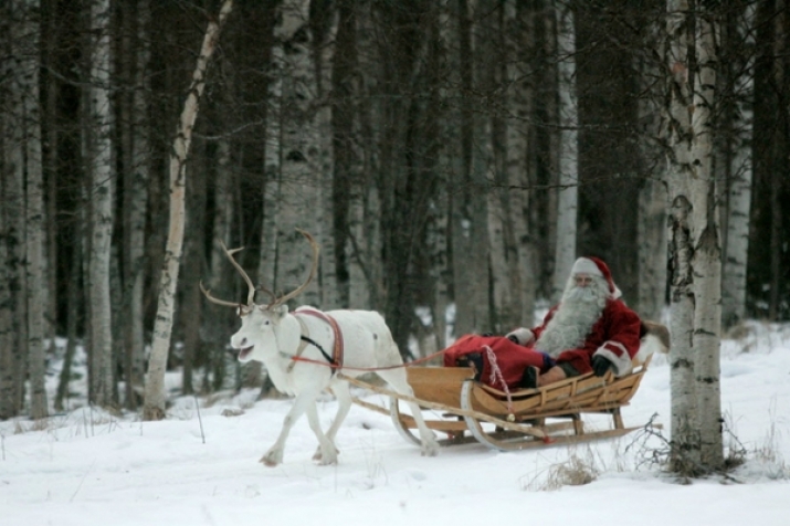 A man dressed as Santa Claus is pulled by a reindeer in Rovaniemi, Finland. Photo by Kacper Pempel. From csmonitor.com