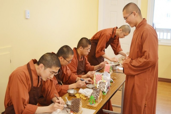 Venerable Xingxun, right, observes four Buddhist monks hard at work on special gingerbread houses. From theguardian.com