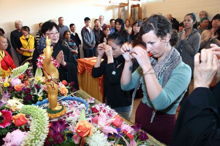 Devotees making offerings at the nunnery altar. Image courtesy of Po Lam Buddhist Association