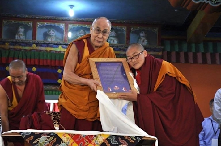 A nun receives the Geshema degree from His Holiness the Dalai Lama. From phayul.com