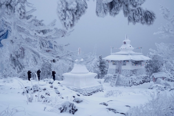 Buddhist novices pay their respects at two of the monastery's stupas. Photo by Amos Chapple. From rferl.org