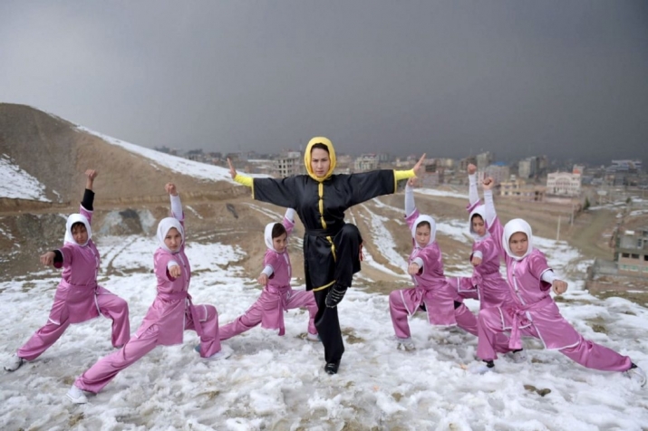 Members of the Shaolin Wushu Club in Kabul, led by trainer Sima Azimi, center, practice on a hilltop overlooking Kabul. Photo by Wakil Kohsar. From thestar.com