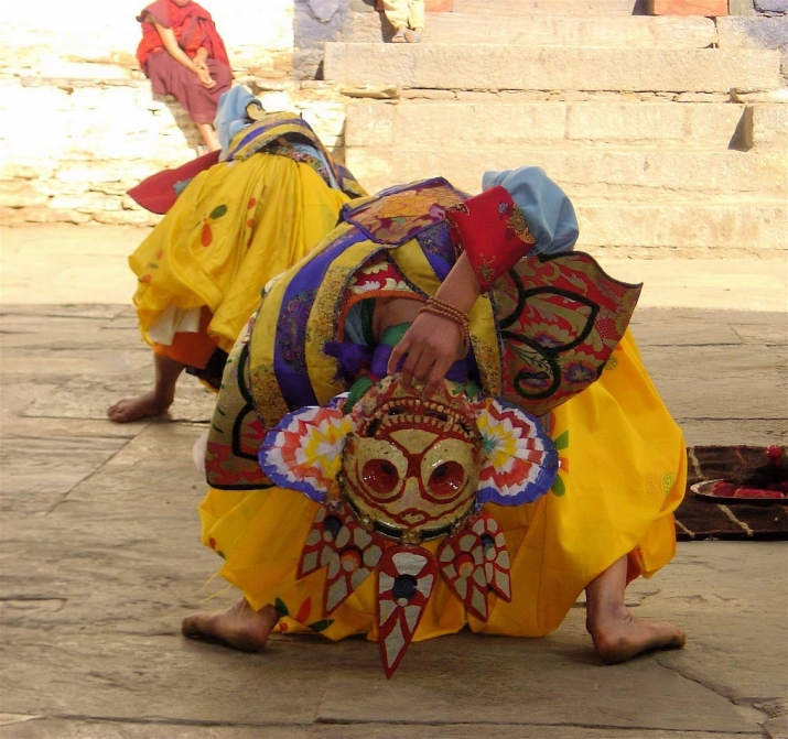 Tourdag, keepers of the charnal grounds, perform extraordinary back bends as they munch on human flesh. Yungdrung Choeling Dzong, Bhutan, 2006. Photo from Core of Culture