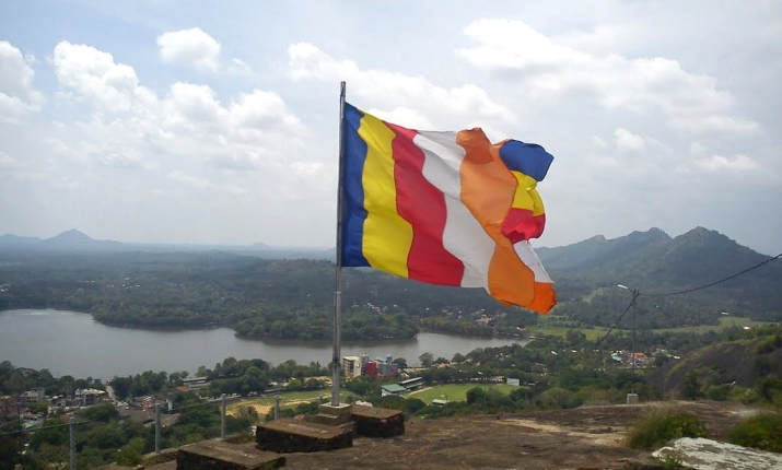 A Buddhist flag billowing atop Athugala Rock, Sri Lanka. From panoramio.com